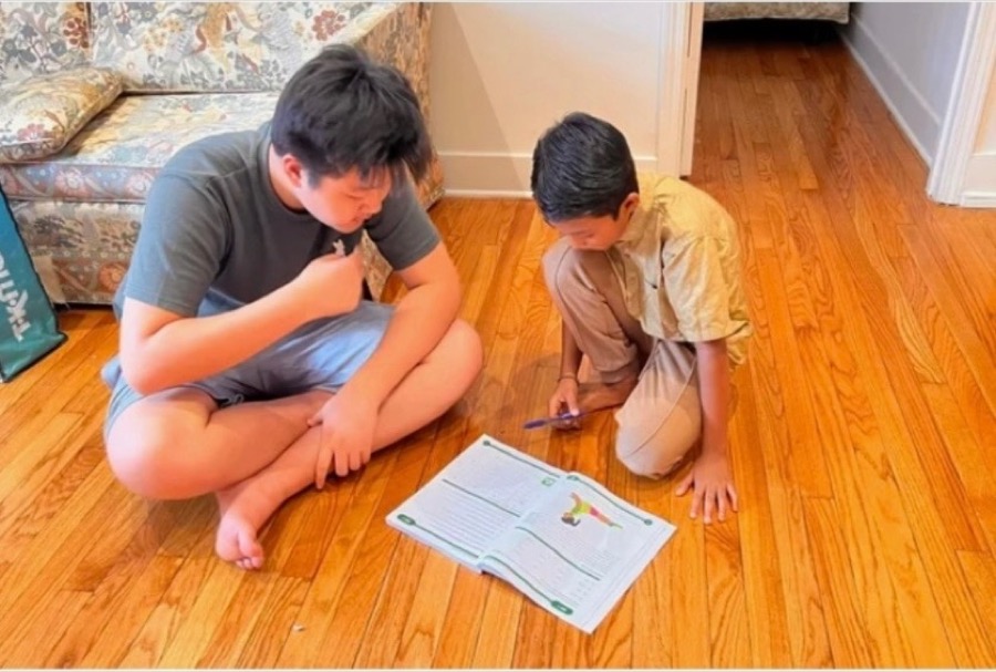A volunteer tutoring a student